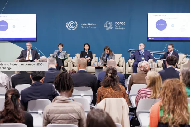 People in a room pictured at COP29. Photo: UN Climate Change - Kamran Guliyev