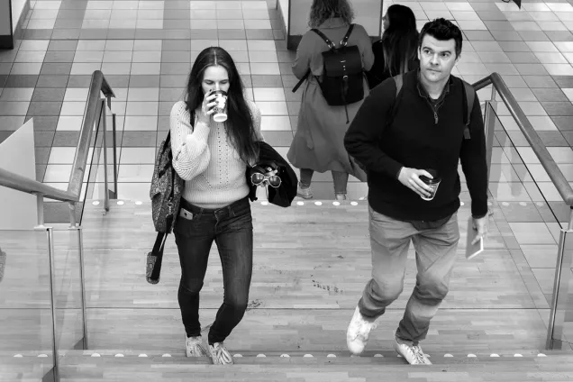 two students walking up a staircase. Photo